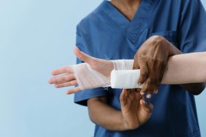 Nurse wrapping gauze around wrist